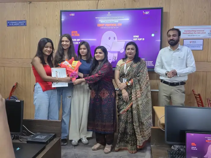 Winners holding prizes alongside the faculty council
