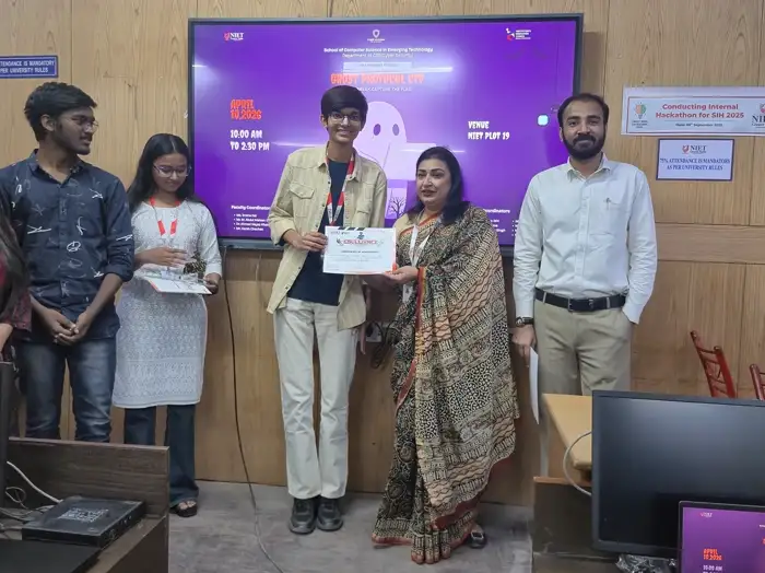 Winner with a certificate beside the faculty coordinator